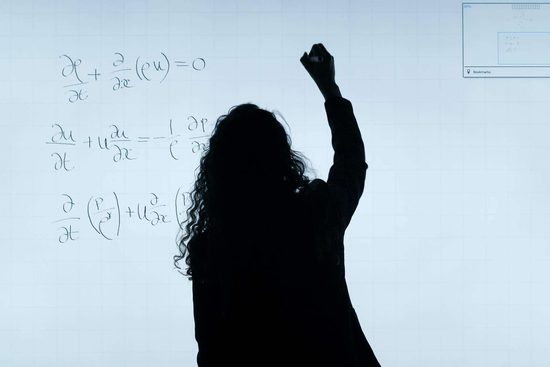 A person standing in front of a white board